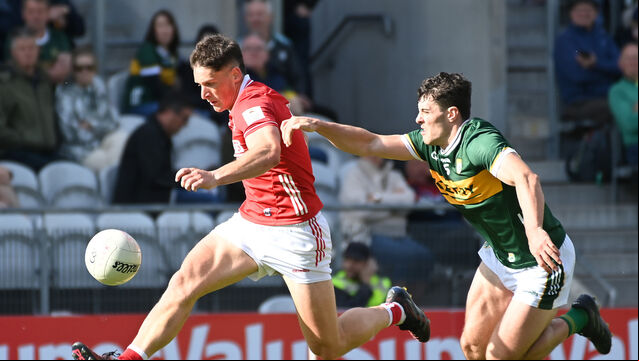 <p>Cork's Colm O'Callaghan solos past Kerry's Mike Breen at SuperValu Páirc Uí Chaoimh. Picture: Eddie O'Hare</p>